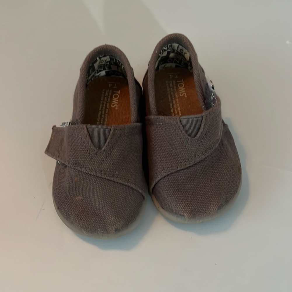 Toms Tiny Classics in ash/grey canvas. Brand new in box. Never worn.